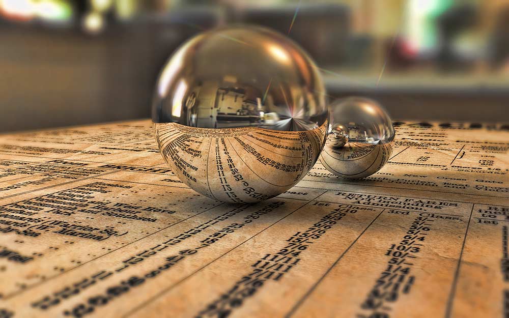 Photograph of mirror balls on written pages