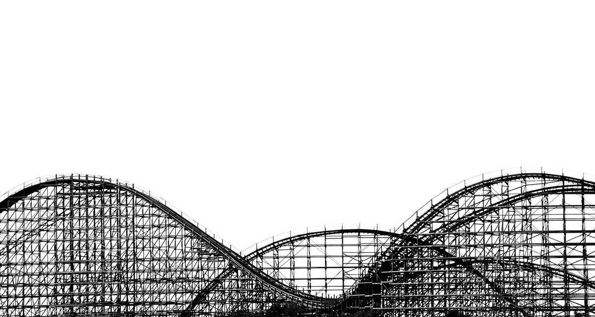 Black and white photograph of the loops of a wooden rollercoaster